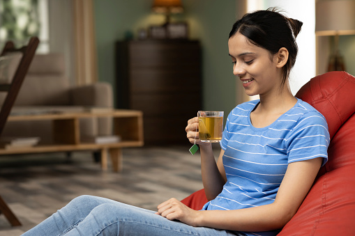 Young woman drinking green tea