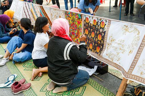 Yogyakarta, Indonesia - October 1, 2019 : drawing batik cloth outdoors