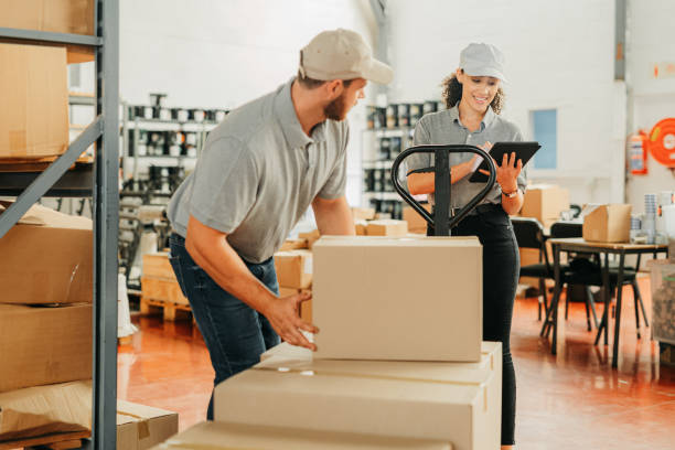 istock Warehouse management packing boxes on trolley for cargo logistics, delivery and shipping in wholesale factory, distribution depot and industry. Staff planning stock, courier package and supplier post 1426477155