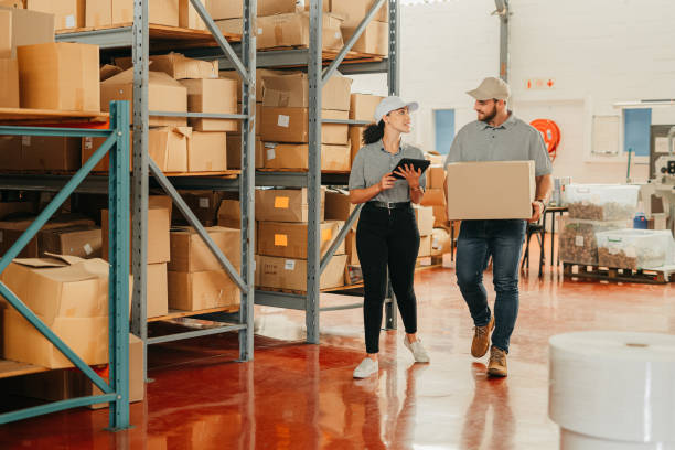 istock Ecommerce, teamwork and supply chain management, courier company employees get package for transport. Logistics worker in warehouse, man and woman with inventory list on tablet and boxes for delivery 1426479179