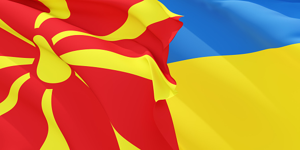 Macedonian and Ukrainian flags flying in the wind. North Macedonia stand with Ukraine. 3D rendered image.