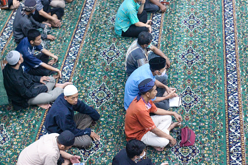 Yogyakarta, Indonesia - May 12, 2022: Praying in congregation at the Jogokariyan Mosque, Yogyakarta