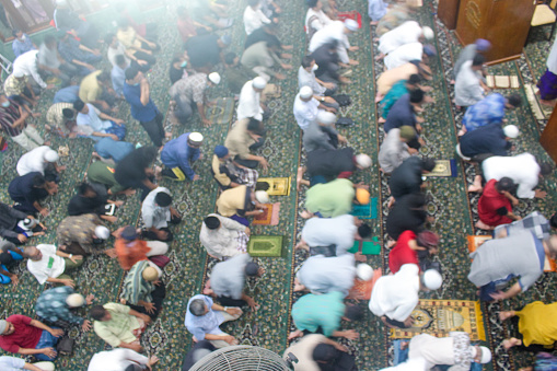 Yogyakarta, Indonesia - May 12, 2022: Praying in congregation at the Jogokariyan Mosque, Yogyakarta