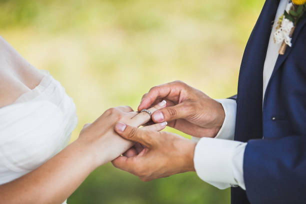 Bride and groom exchange rings at the wedding ceremony