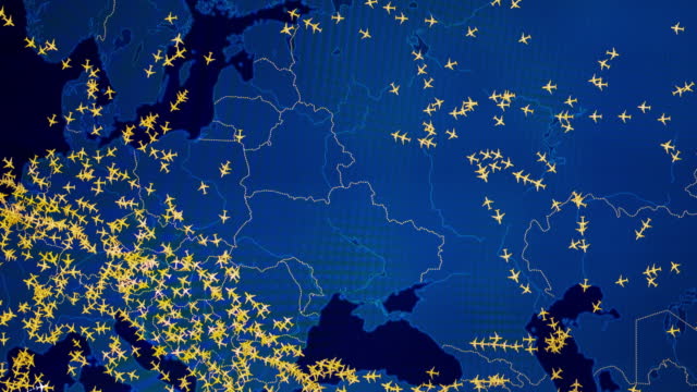 Time lapse of busy air traffic over map on digital screen.