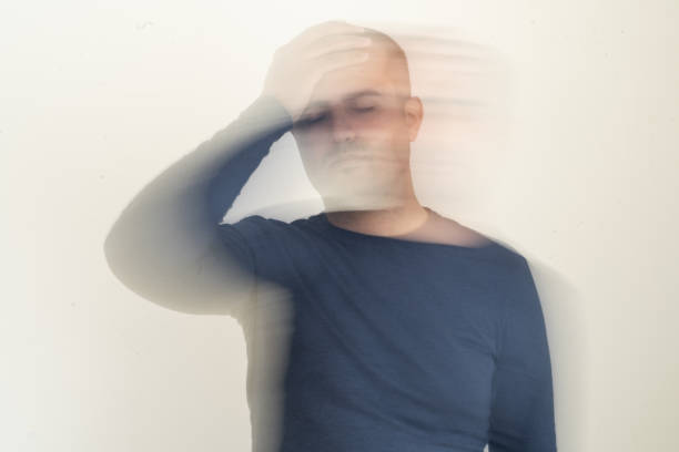 Close up photo of man with vertigo illness. Motion blur effect intentionally applied. Dizziness and tension and medicine side effect concept.
