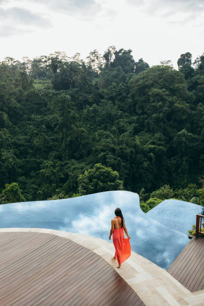 istock Young woman walking by the pool 1426499334