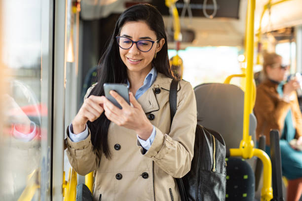 Woman using mobile phone at the public transport stock photo