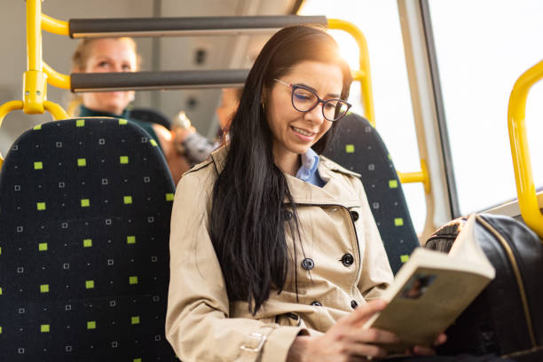 istock Woman holding a book while traveling by bus 1426499911