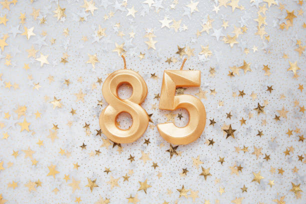 istock Number 85 eighty five golden celebration birthday candle on Festive Background. 1426500252
