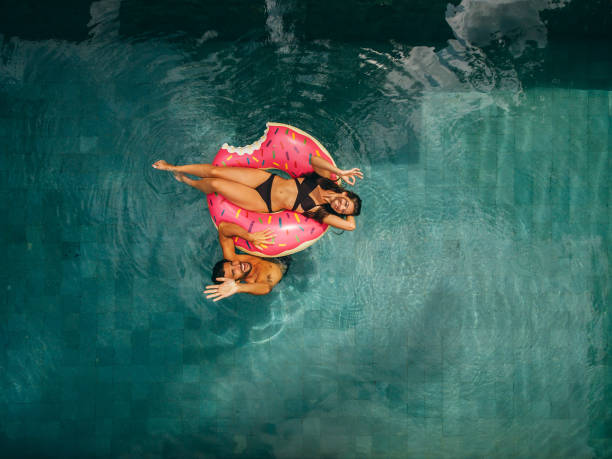 istock Couple enjoying vacation in resort pool 1426500415