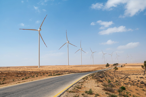 Wind farm in highlands of Jordan, Middle East rising above the mountain road. Wind farm or wind park, also called a wind power station or wind power plant, is a group of wind turbines in the same location used to produce electricity