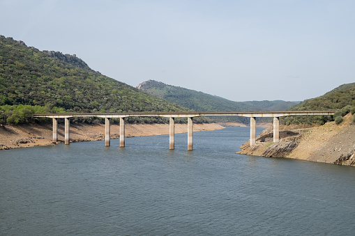 The old Cardenal bridge over Tagus river in the center of the National Park of Monfrague.