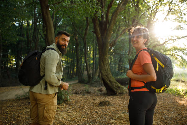istock Cheerful young man going on a forest hike with his mother, looking at camera and smiling 1426513046