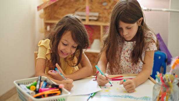 istock Sisters at home drawing and painting together 1426513363