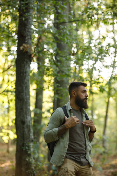 istock Young man casually walking through the forest, contemplating during a hike 1426514278