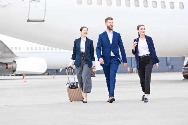 istock Business team walking in front of airplane 1426534438