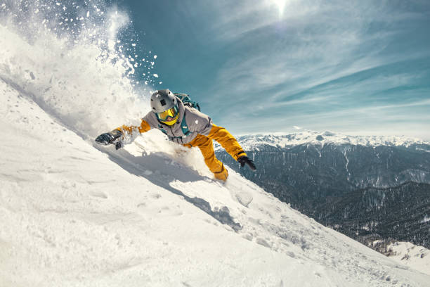 Real professional snowboarder rides at ski slope Real professional snowboarder rides at off-piste ski slope. Winter sports concept adrenaline stock pictures, royalty-free photos & images
