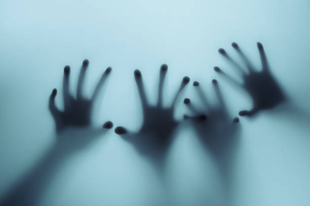 istock Shadow of a zombie hand on white background 1426541380
