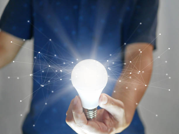 istock Man holding bright shining light bulb represents a new idea, thought, invention, innovation, solution, creativity, technology, and business with network connection links 1426542154