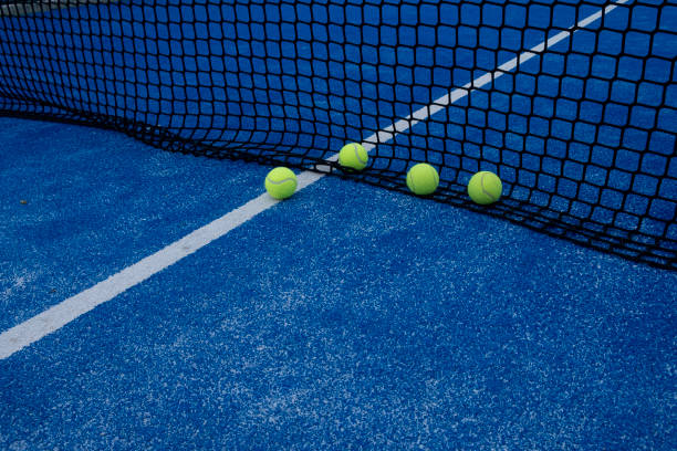 istock various balls by the net on a blue paddle tennis court 1426543022