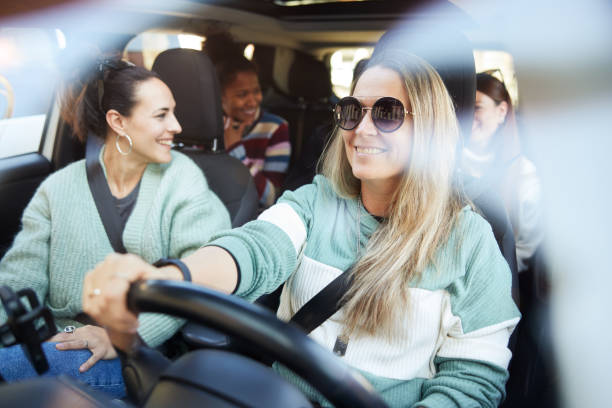 Group of friends on a road trip inside a car. stock photo