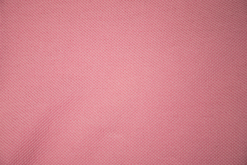 Pink clothes textured background. Close up.