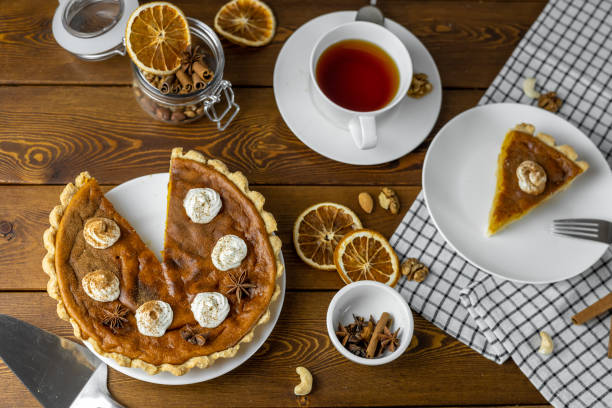 istock pumpkin pie with whipped cream and cinnamon on a rustic background, top view 1426546419