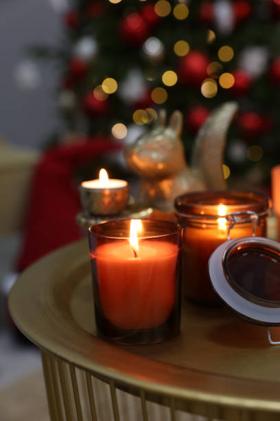 istock Burning candles on table in room decorated for Christmas 1426547734