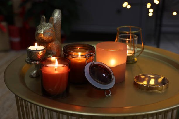 istock Burning candles in different holders on table indoors 1426547844