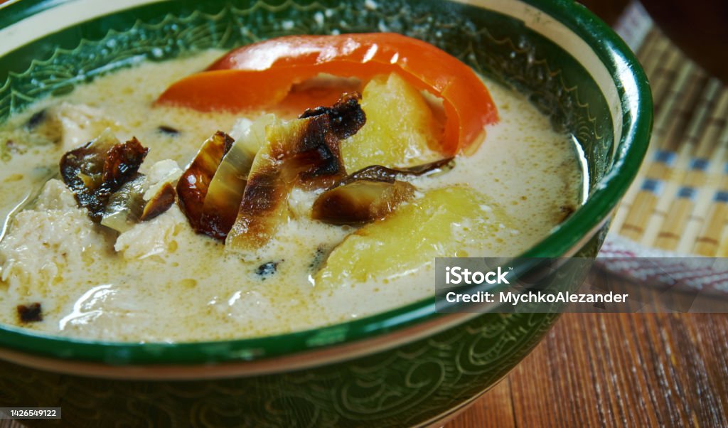 Caucasian  Ossetian Soup Lyvzha Ossetian chicken sour cream Soup Lyvzha Caucasian  cuisine, Traditional assorted dishes, Top view. Chechnya Stock Photo
