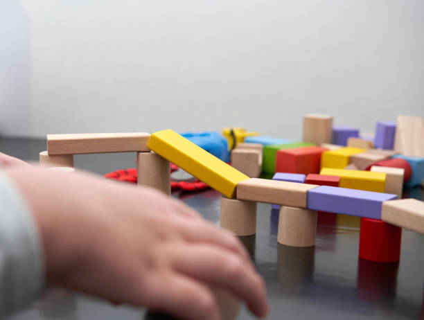 istock child hand play wood block toy 1426549506