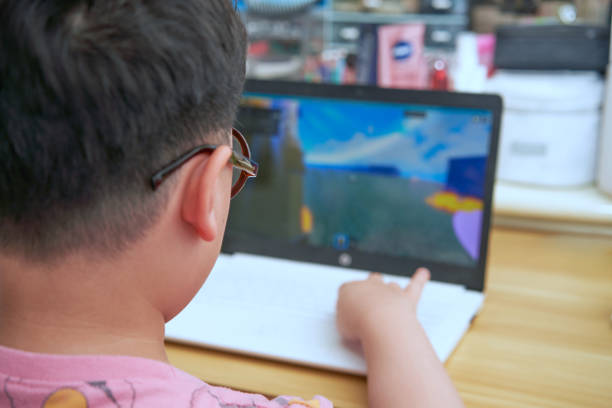 istock child play laptop game with glass selective focus 1426549512