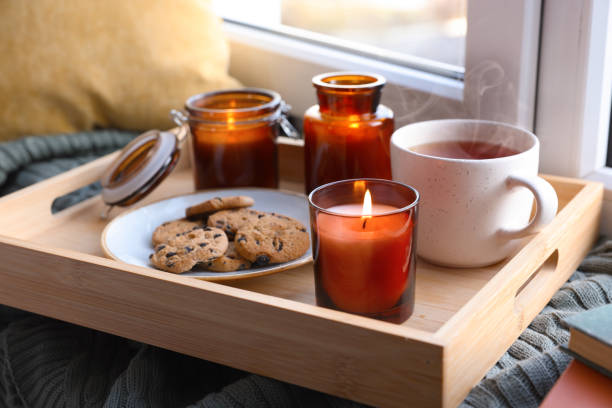 istock Breakfast tray with burning candles near window indoors 1426549638