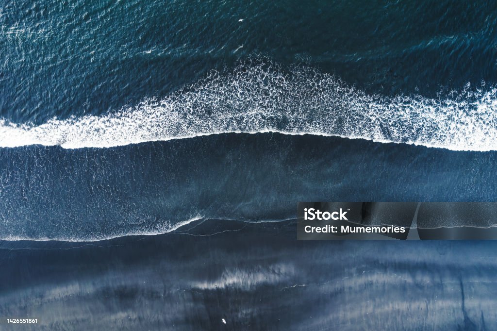 Moody atlantic ocean wave on black sand beach in summer at Iceland Aerial drone view of moody atlantic ocean wave on black sand beach in summer at Iceland Sea Stock Photo