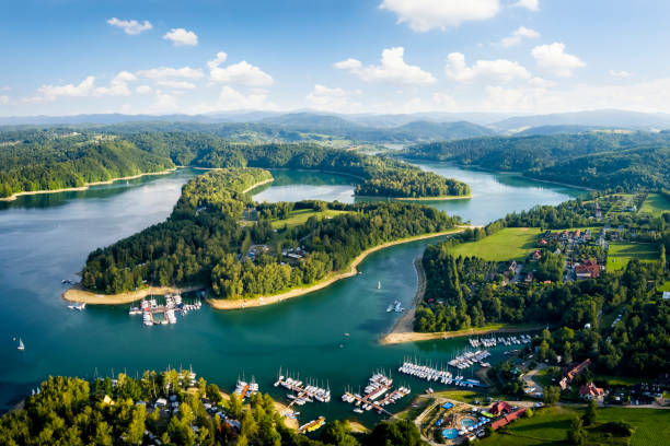Vacations in Poland - Lake Solina Vacations in Poland - view of Lake Solina and the spa village of Polanczyk, Bieszczady Mountains in background polish beach stock pictures, royalty-free photos & images