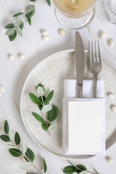 istock Elegant Table setting with a card decorated with eucalyptus branches top view, Wedding mockup 1426555031