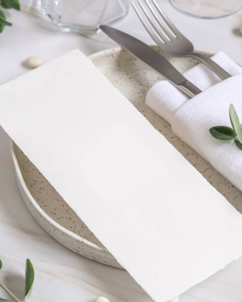 istock Elegant Table setting with a card decorated with eucalyptus branches close up, Wedding mockup 1426555033