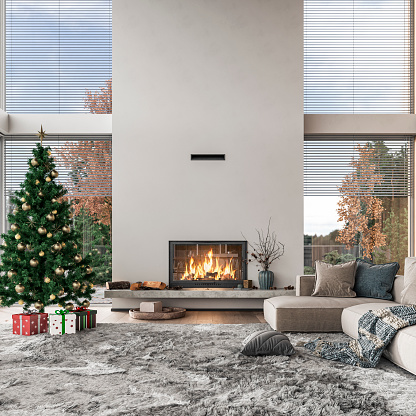 Cozy, luxurious, and empty modern living room with two beige textile sofas on the hairy carpet, and decoration (pillows, blankets, books, eyeglasses) on the hardwood floor in front of a design-shaped modern fireplace in the middle with copy space. A long marble shelf under the fireplace with decorations, logs, candles, and a vase of dry flowers. A few wrapped gifts under the Christmas decorated tree in front of large and high windows with blinds and with a terrace and garden view (winter trees) on both sides of the fireplace.  A slight vintage effect was added. 3D rendered image.