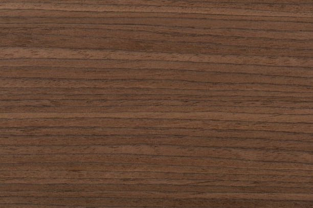 istock Dark brown nut veneer background as part of your design 1426562983