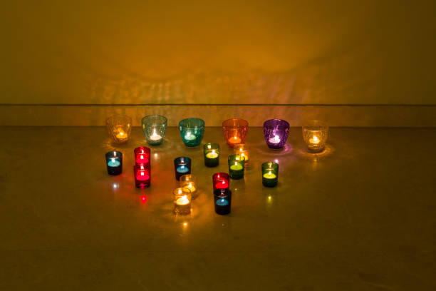 istock Diwali celebrations done with decorating glass candle holders with glowing candle tea lights.Light  reflections on the background. 1426565152