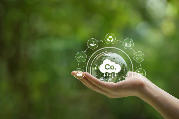 istock Reduce CO2 emission concept. Hand-holding crystal globe with a CO2 icon. Ideas for Sustainable development and green business based on renewable energy. Energy saving, Sustainable development. 1426565340