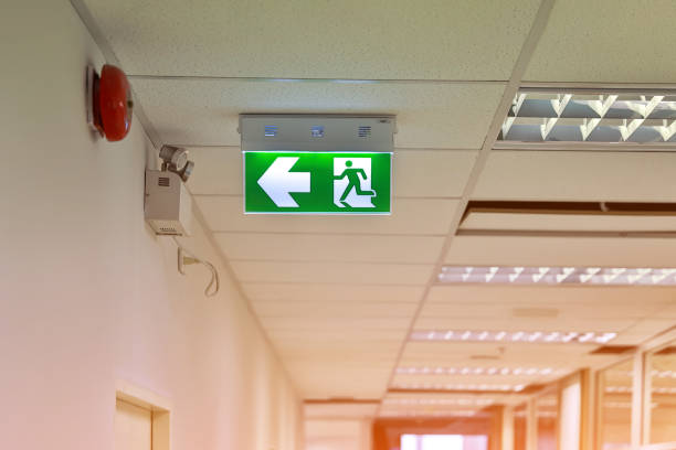 istock Green emergency exit sign showing the way to escape. Fire exit in the building. 1426565620