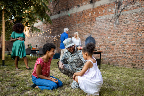 istock Soldier talking to his daughters while kneeling on grass 1426566753