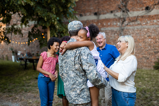 A soldier surprises his family by coming home from the military