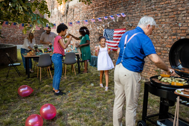 istock Two girls playing with bubbles at an American themed celebration in a back yard 1426570463
