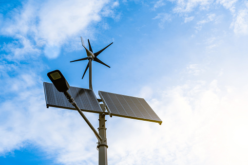Sun energy solar power. Wind turbine with solar energy power panel, renewable photovoltaic technology. Renewable energy sources concept