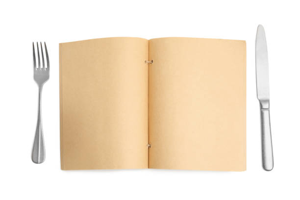 istock Blank recipe book and cutlery on white background, top view. Space for text 1426573981
