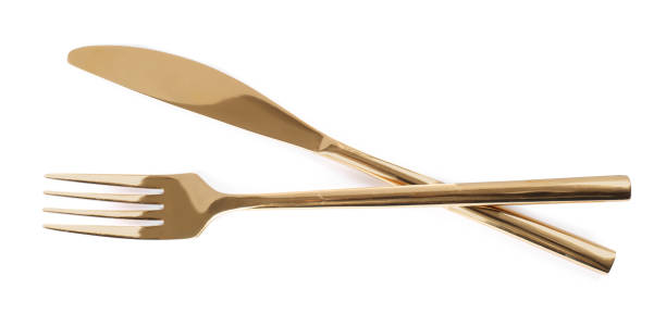 istock New shiny golden fork and knife on white background, top view 1426574159