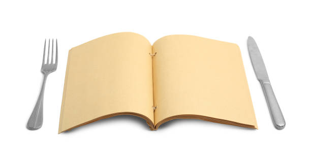 istock Blank recipe book and cutlery on white background. Space for text 1426575505